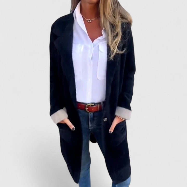 Woman wearing black brushed knit blazer with hands in pockets