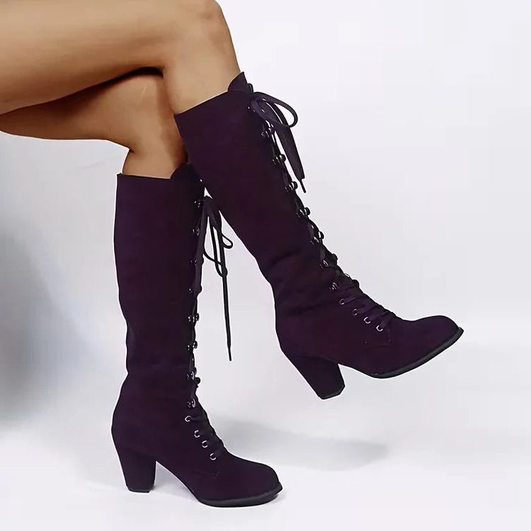 Purple lace-up knee high boots worn while seated