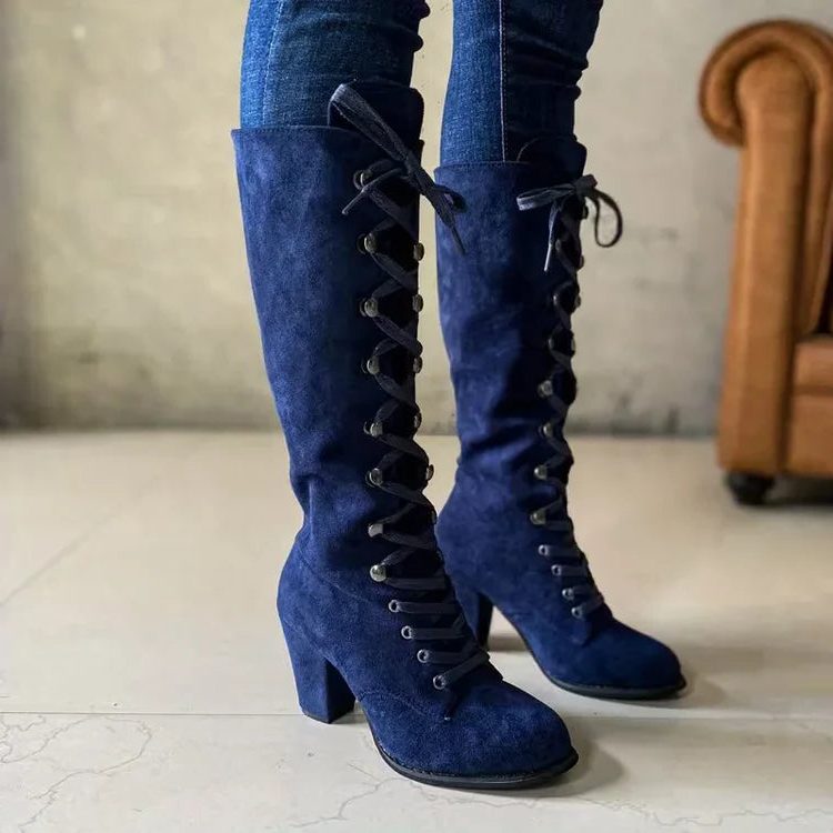 Blue suede lace-up knee high boots with block heel worn with jeans
