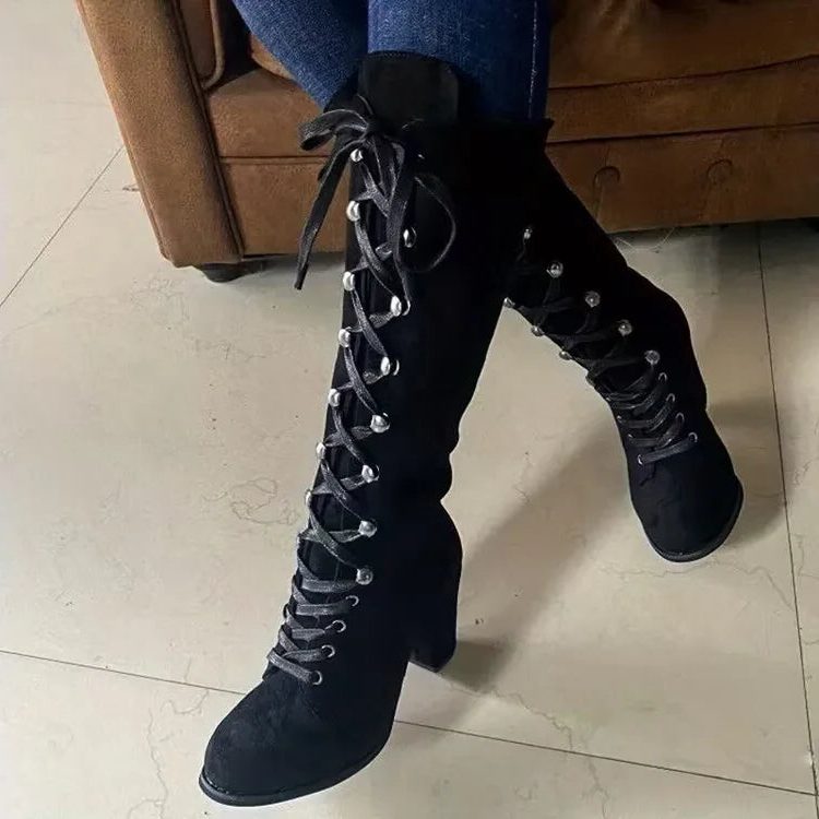 Black suede lace-up knee high boots with block heel worn with jeans