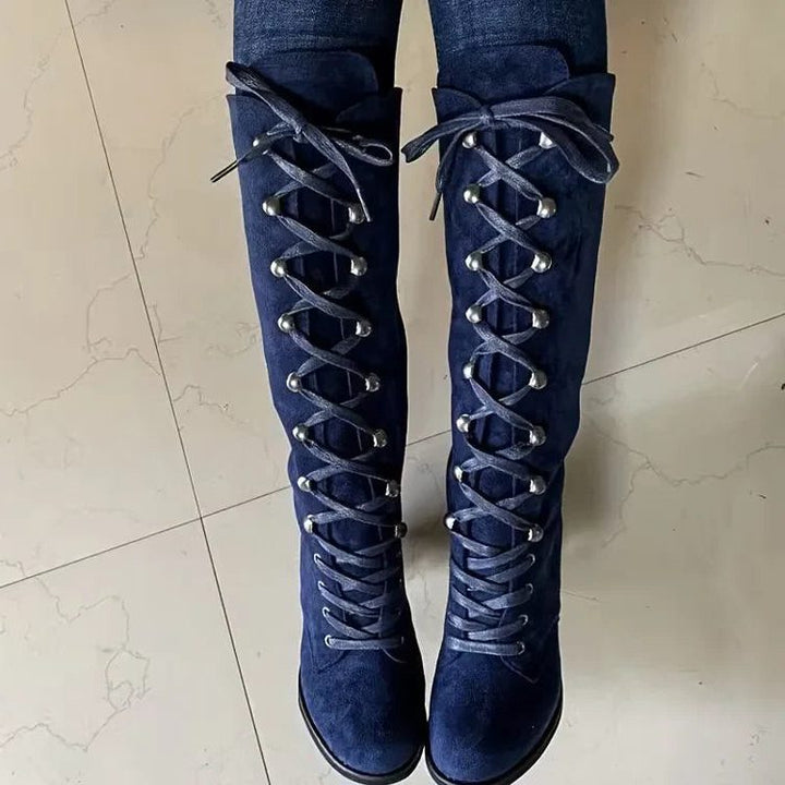 Front view of blue lace-up knee high boots with metal grommets
