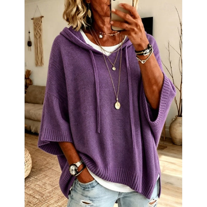 Purple hooded sweater worn with layered necklaces, front view