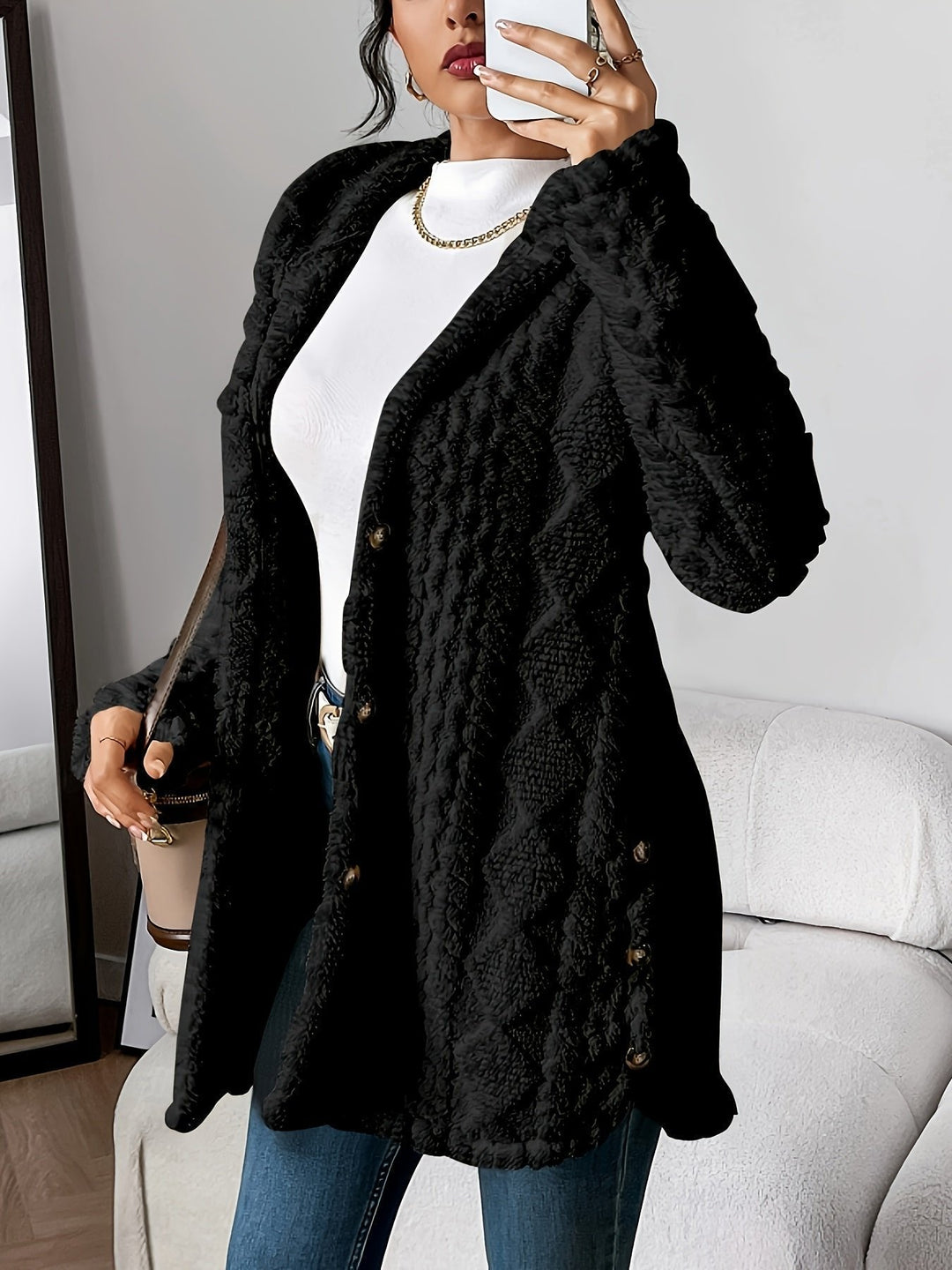 Woman wearing black textured fleece hooded cardigan