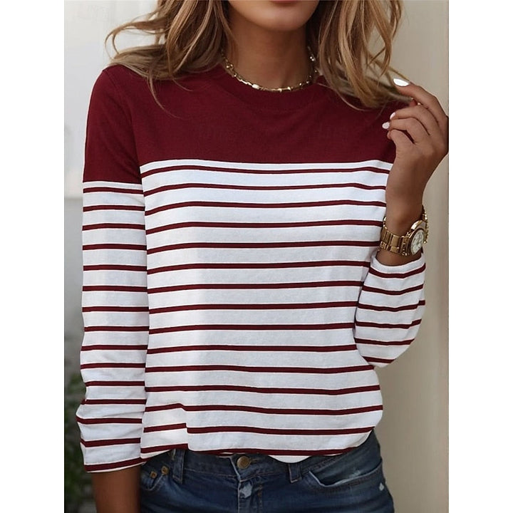 Close-up of burgundy and white striped long sleeve top with color block yoke
