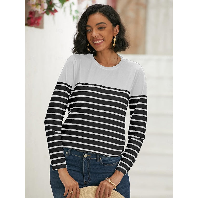 Woman wearing white and black striped long sleeve top